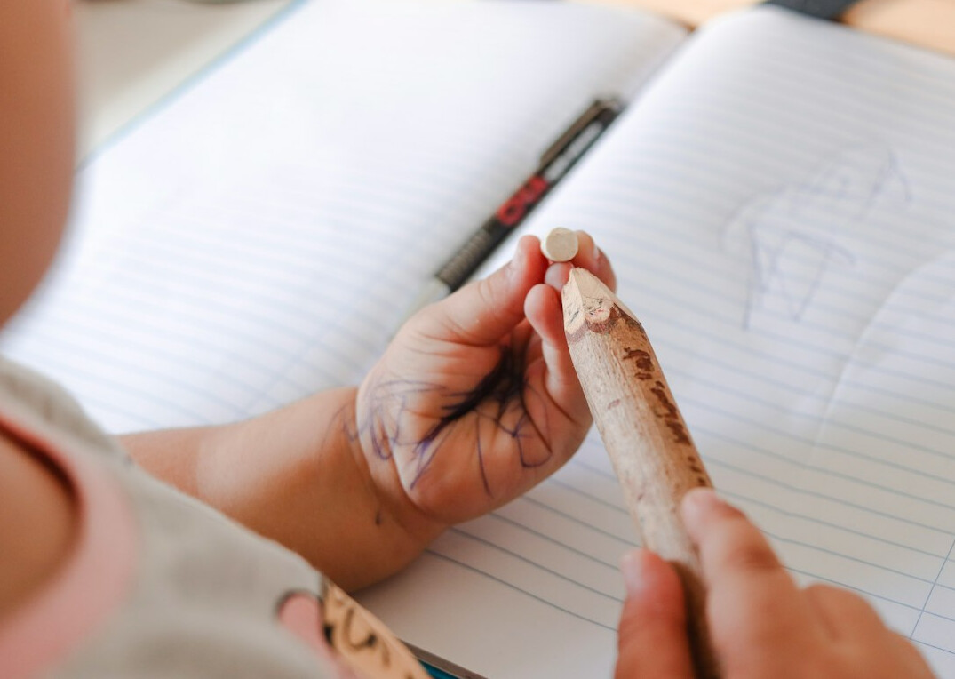 Hands writing notes in a notebook