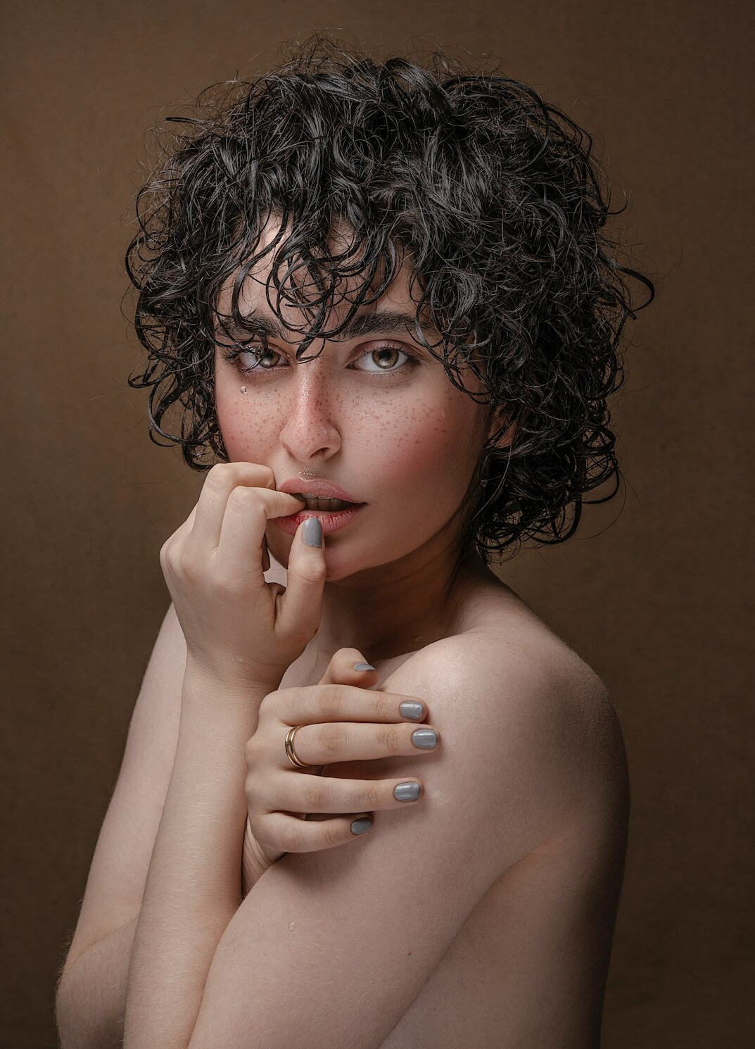 Studio portrait of a woman with curly hair